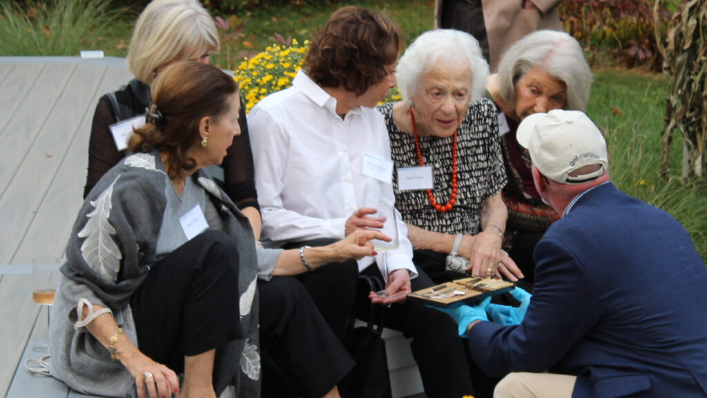 Members of the Berkshire Museum’s Crane Society get an up-close look at an object during a special Crane Society event in 2019.