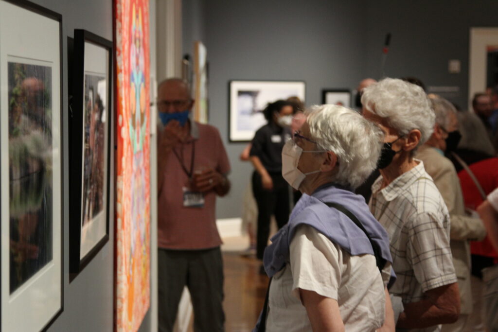 People viewing artworks at a previous Art of the Hills event