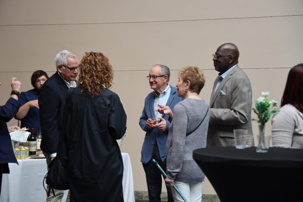 A group of people at a previous members exclusive exhibit opening